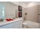 Well-lit bathroom with double vanity, tub/shower combination, and modern tile accents at 938 Hearteye Trl, Lafayette, CO 80026