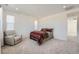 Bright bedroom with plush carpeting, recessed lighting, and a cozy sitting area at 938 Hearteye Trl, Lafayette, CO 80026