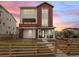 Charming two-story home featuring a modern design, front porch, and a neatly landscaped yard at 938 Hearteye Trl, Lafayette, CO 80026