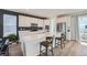 Modern kitchen featuring white cabinets, quartz countertops, stainless steel appliances, and island seating at 938 Hearteye Trl, Lafayette, CO 80026