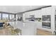 Spacious kitchen with white cabinetry, stainless steel appliances, and an oversized center island with seating at 938 Hearteye Trl, Lafayette, CO 80026