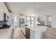 Bright kitchen featuring a large island, modern appliances, and access to the staircase at 938 Hearteye Trl, Lafayette, CO 80026