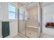 Luxurious tiled shower with seamless glass door and window, offering natural light at 938 Hearteye Trl, Lafayette, CO 80026