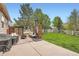 Spacious backyard with patio, outdoor seating, privacy screens, and well-maintained lawn at 23882 E Alabama Dr, Aurora, CO 80018