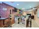 Finished basement bar area with brick accent wall, shelving, tap and barstool seating at 23882 E Alabama Dr, Aurora, CO 80018