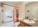 Bathroom with a shower-tub combination, a toilet, and a single sink vanity with a large mirror at 23882 E Alabama Dr, Aurora, CO 80018
