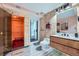 Modern bathroom with stylish wood paneling, sauna, a glass-enclosed shower and sleek vanity at 23882 E Alabama Dr, Aurora, CO 80018