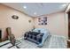 Cozy bedroom featuring modern plank flooring, a comfortable bed, and decorative wall art at 23882 E Alabama Dr, Aurora, CO 80018
