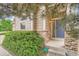 Charming front entrance featuring stone accents, lush greenery, and a stylish blue door at 23882 E Alabama Dr, Aurora, CO 80018