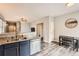 Modern kitchen with stainless steel appliances, granite countertops, and an adjacent dining area at 23882 E Alabama Dr, Aurora, CO 80018