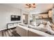 Spacious living room with a comfortable sofa, open layout, and adjacent dining area at 23882 E Alabama Dr, Aurora, CO 80018