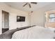 Spacious main bedroom featuring a ceiling fan, a large television, and neutral carpeting at 23882 E Alabama Dr, Aurora, CO 80018