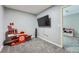 Playroom includes a play cash register, toy shopping carts, and a wall-mounted television at 23882 E Alabama Dr, Aurora, CO 80018