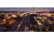 Night aerial view showcasing Olde Town Arvada with a water tower, roads, train, and residential buildings at 5195 Allison St, Arvada, CO 80002