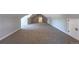 Finished attic features neutral carpet, white trim, and angled ceilings with dormer windows at 5195 Allison St, Arvada, CO 80002