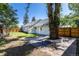 Private backyard with a brick patio, mature tree, and lush lawn, perfect for outdoor entertaining and relaxation at 5195 Allison St, Arvada, CO 80002