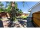 Landscaped backyard with a brick patio, green lawn, mature tree, and a wooden fence, perfect for outdoor living at 5195 Allison St, Arvada, CO 80002