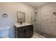 This bathroom features a vanity and a shower with designer marble tile at 5195 Allison St, Arvada, CO 80002