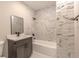 Modern bathroom features sleek marble hexagon tile, contemporary fixtures, and a tub for a luxurious bathing experience at 5195 Allison St, Arvada, CO 80002