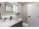 Modern half bathroom features sleek fixtures, a stylish mirror, and a clean, minimalist design at 5195 Allison St, Arvada, CO 80002
