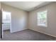 Neutral carpeted bedroom with closet and white-painted walls has a sunny window and door at 5195 Allison St, Arvada, CO 80002