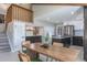 Charming dining area with an open layout, stainless steel kitchen appliances, and staircase to the second floor at 5195 Allison St, Arvada, CO 80002