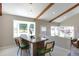 Dining room with wood beams, large windows, and a wooden table perfect for gatherings at 5195 Allison St, Arvada, CO 80002