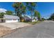 Exterior view showcasing the detached garage and the back side of the charming residence at 5195 Allison St, Arvada, CO 80002