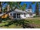 Exterior view of a charming home featuring stone chimney and mature trees on a sunny day at 5195 Allison St, Arvada, CO 80002