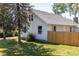 View of the back of a single-story home, showcasing white siding, grey roof and a lawn at 5195 Allison St, Arvada, CO 80002