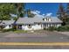 Charming single-story home featuring white siding, gray shingle roof, and lush landscaping at 5195 Allison St, Arvada, CO 80002