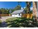 View of a detached garage with white doors and siding and new fence at 5195 Allison St, Arvada, CO 80002