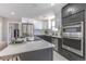 Modern kitchen with stainless steel appliances, a center island with bar stools, and stylish cabinetry at 5195 Allison St, Arvada, CO 80002