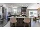 Modern kitchen with stainless steel appliances, a center island with bar stools, and stylish cabinetry at 5195 Allison St, Arvada, CO 80002
