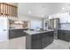Modern kitchen with stainless steel appliances, a center island with bar stools, and stylish cabinetry at 5195 Allison St, Arvada, CO 80002