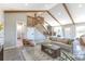 Open-concept living room showcasing vaulted ceilings, beams, and staircase to the second floor at 5195 Allison St, Arvada, CO 80002
