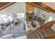 Bright living room featuring a brick fireplace, wood beams and large windows offering plenty of natural light at 5195 Allison St, Arvada, CO 80002
