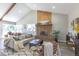 Spacious living area with a fireplace, neutral sofa and rustic furnishings under a vaulted ceiling at 5195 Allison St, Arvada, CO 80002