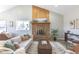 Comfortable living room boasts a brick fireplace, wood accents, and a stylish neutral color palette at 5195 Allison St, Arvada, CO 80002