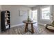 Living room with neutral walls, area rug, and a round wooden table at 5195 Allison St, Arvada, CO 80002