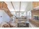 Bright living room featuring a fireplace, staircase, and plenty of natural light at 5195 Allison St, Arvada, CO 80002