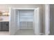 Pantry with white shelving and bi-fold doors offering lots of storage space at 5195 Allison St, Arvada, CO 80002