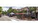 Charming street view featuring shops, outdoor seating, and pedestrian activity on a sunny day at 5195 Allison St, Arvada, CO 80002