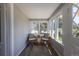Cozy sunroom featuring large windows, comfortable seating, and natural light, perfect for relaxation and enjoying the outdoors at 5195 Allison St, Arvada, CO 80002