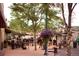 Vibrant town square with outdoor seating, string lights, and lush floral arrangements creating a welcoming ambiance at 5195 Allison St, Arvada, CO 80002