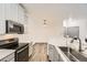 Well-lit kitchen featuring stainless steel appliances and a view into the adjacent room at 18657 Stroh Rd # 4103, Parker, CO 80134