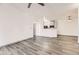 Open-concept living room with hardwood floors, white walls, and a view of the kitchen at 18657 Stroh Rd # 4103, Parker, CO 80134