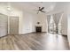 Bright living room featuring a fireplace, ceiling fan, and large window with gray curtains at 18657 Stroh Rd # 4103, Parker, CO 80134