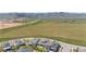 Expansive aerial view of the property with neighboring houses and open fields leading up to the mountains at 9340 Mount Jackson St, Littleton, CO 80125