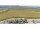 Aerial view of community homes backing to open space with mountain views in the distance at 9340 Mount Jackson St, Littleton, CO 80125